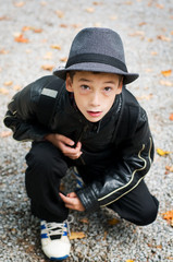 smiling 9 year old boy wearing a fedora hat