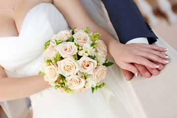 Obraz na płótnie Canvas Hand of the groom and the bride at a wedding party