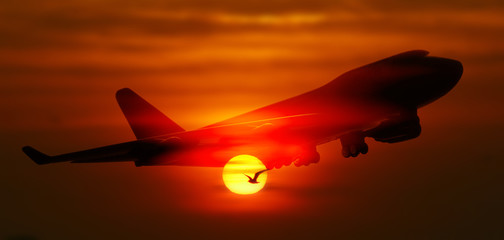 Naklejka na ściany i meble passenger plane on sky at sunset time very beautiful , use for air transport ,journey and travel industry business
