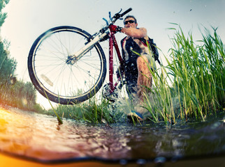 Young man crossing the swamp