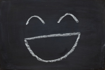 smile emotion face on black chalk board
