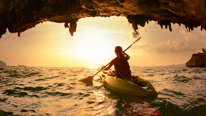 Young lady paddling the kayak