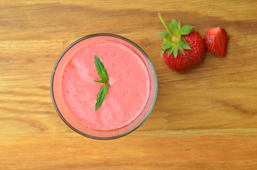 Top view of strawberry milkshake (Focus on mint leaves)