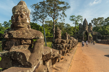 Fototapeta premium gods and demons in the access bridge to victory's gate in siam reap, cambodia
