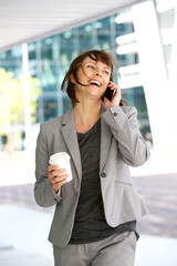 Businesswoman walking and talking in the city