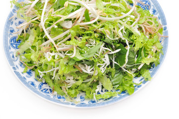 Dish of Vietnamese herbs on a white background
