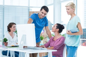Three casual colleagues using computer