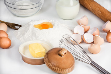 baking background with raw eggs, sugar, flour , milk and butter