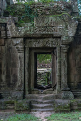 Fototapeta na wymiar door with bas-reliefs of the royal palace in the archaeological angkor thom place in siam reap cambodia