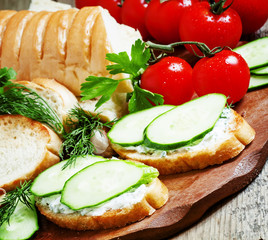 Bruschetta with white sauce and cucumber, selective focus