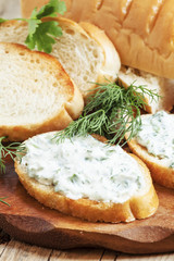 Bruschetta with white sauce and herbs, selective focus