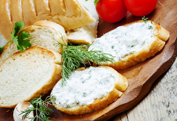 Bruschetta with white sauce and herbs, selective focus