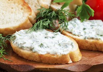 Bruschetta with white sauce and herbs, selective focus