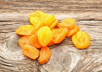 dried apricots on wooden background