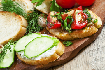 Two types of sandwiches: tomato and cucumber, selective focus