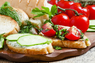 Two types of sandwiches: tomato and cucumber, selective focus