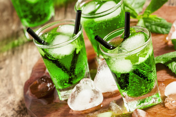Green cocktail with tarragon, mint soda and ice, selective focus