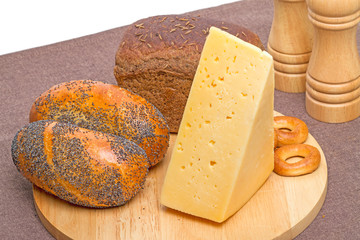 Bakery products and cheese on a cutting board