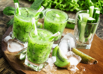 Fresh green juice with kiwi and ice, selective focus