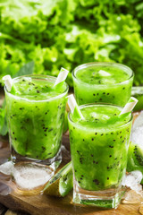 Fresh green juice with kiwi and ice, selective focus