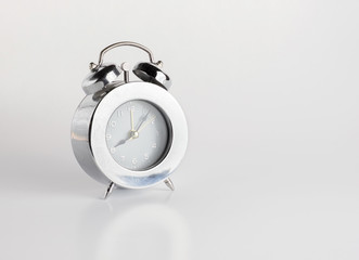 sliver alarm clock on gery background