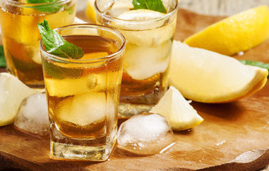 Fresh Cold black tea with lemon, mint and ice selective focus
