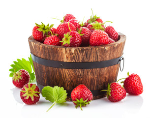 Fresh strawberry in wooden bucket with green leaf. Isolated on