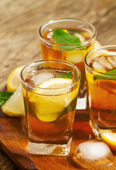 Fresh Cold black tea with lemon, mint and ice selective focus