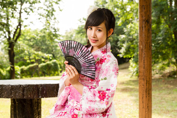 Asian woman in Japanese garden