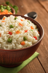 bowl full of rice on wood