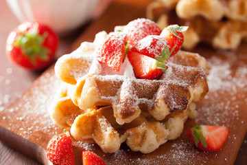 belgian waffles with icing sugar and strawberry