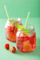 Fototapeta na wymiar summer strawberry drink with lime and mint in jars