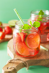 summer strawberry drink with lime and mint in jars