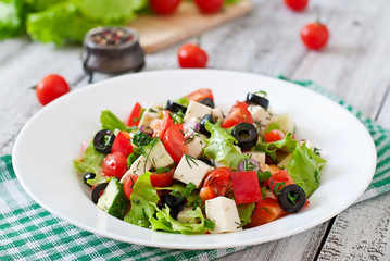 Greek salad with fresh vegetables, feta cheese and black olives