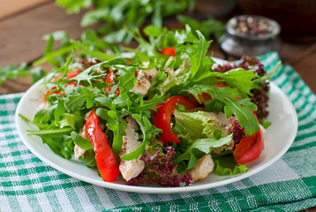 Dietary salad with chicken, arugula and sweet red pepper