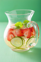 refreshing summer drink with strawberry cucumber lime in jar