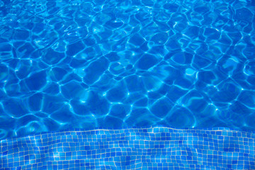 Blue tiles swimming pool water texture