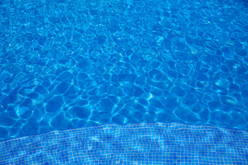 Blue tiles swimming pool water texture