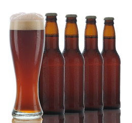Four Brown Beer Bottles and Full Glass