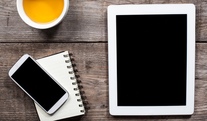 business desk with tablet , mobile phone and tea