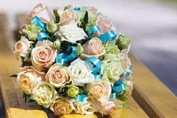 Wedding bridal bouquet lying on a park bench.