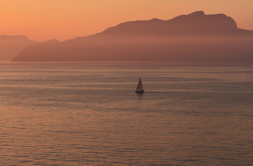 Fototapeta premium Dawn on sea, sailing vessel. Capri, Italy