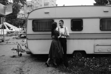 man and woman is hidden from view behind a trailer