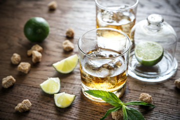 Glass of rum on the wooden background