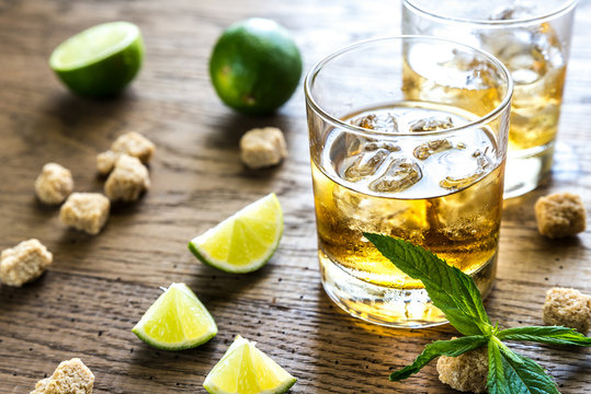 Glasses Of Rum On The Wooden Background