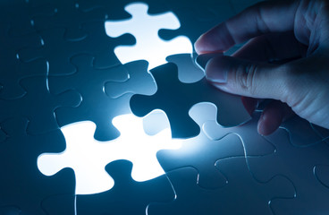 Hand insert jigsaw, conceptual image of business strategy, decis