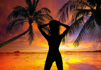 Silhouette of a pretty woman on the tropical beach