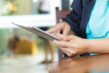Cropped view of women using a digital tablet