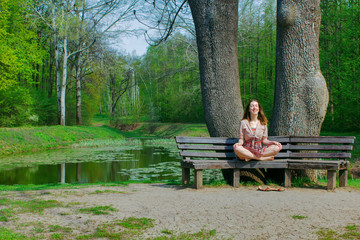 Young girl doing yoga in the park