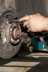 mechanic fixes brakes